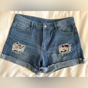 Jeans ripped shorts with leopard patch work.
